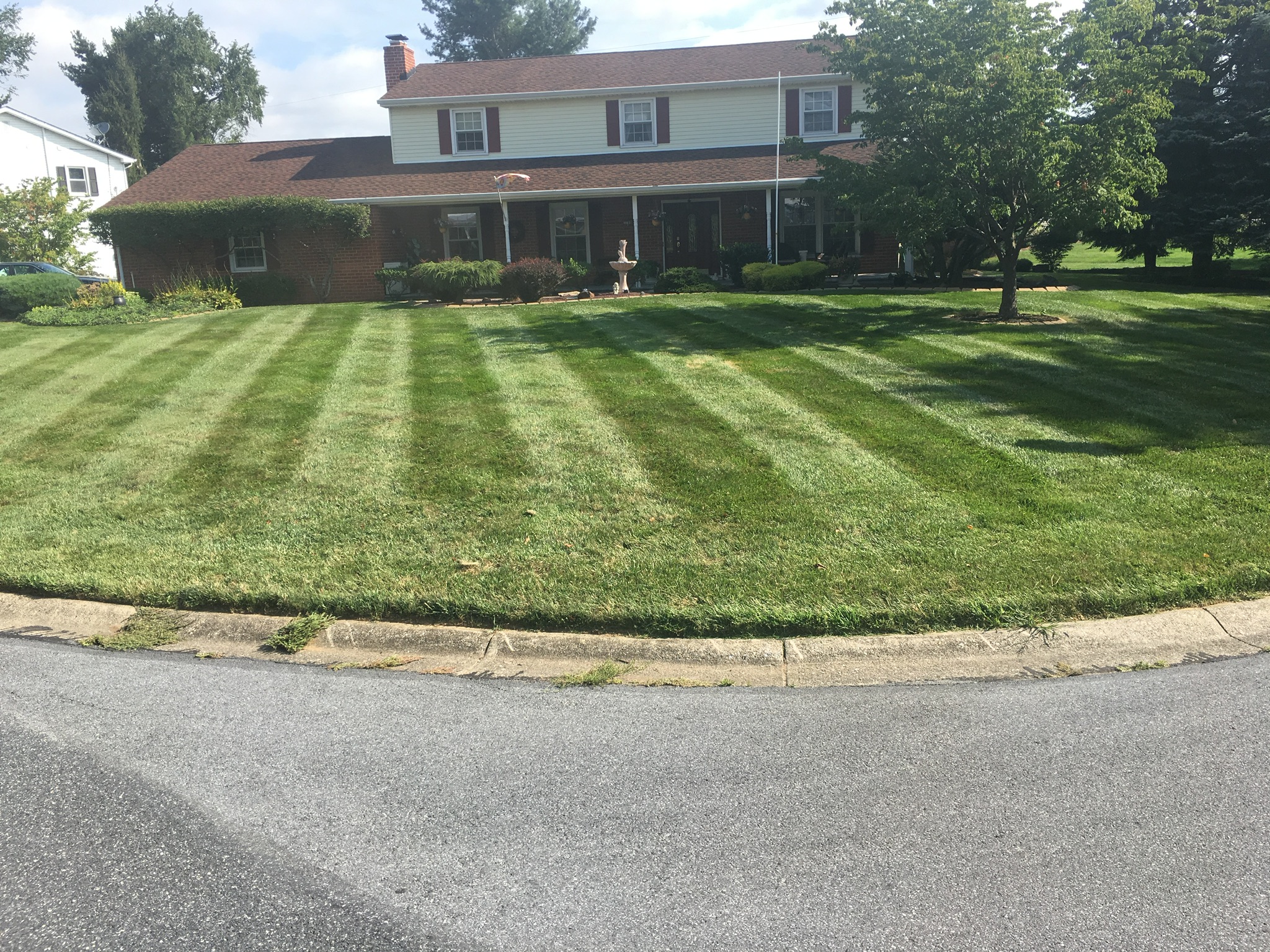 Striped lawn at colonial home